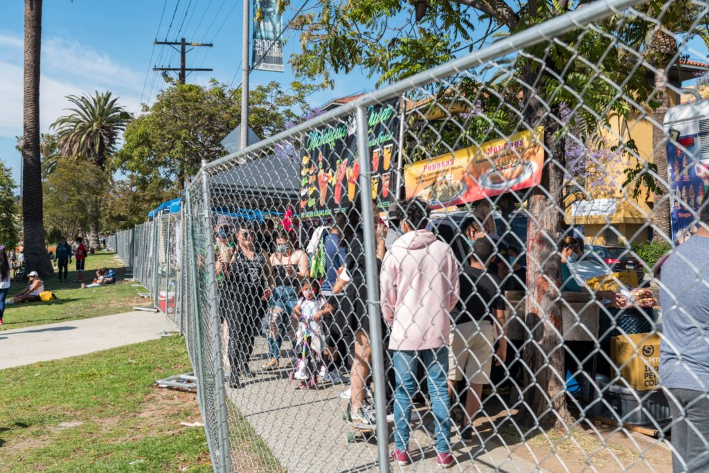 A fence encompasses the entirety of Echo Park Lake.